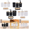 Collection of black and white bathroom accessories with wooden accents on a white background.