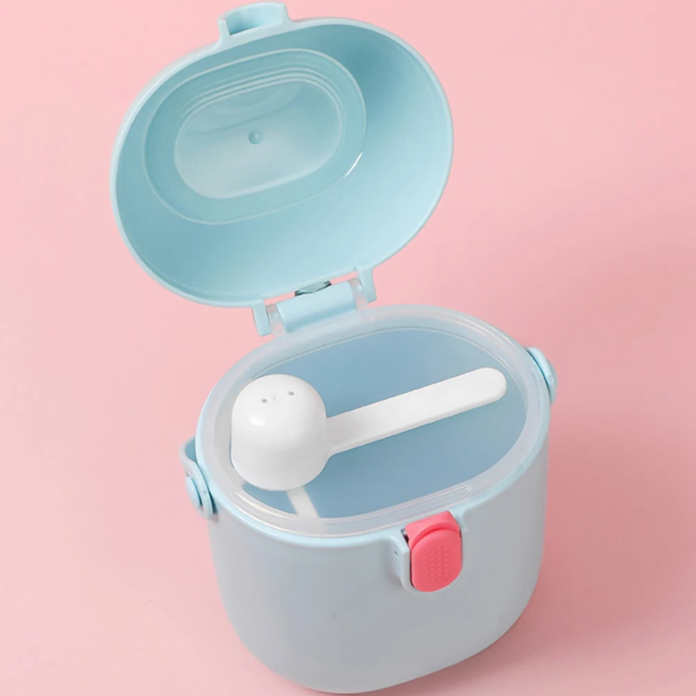 Light blue baby food storage container with a white spoon on a pink background