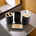 Bathroom accessories set on a counter with black and wooden elements.