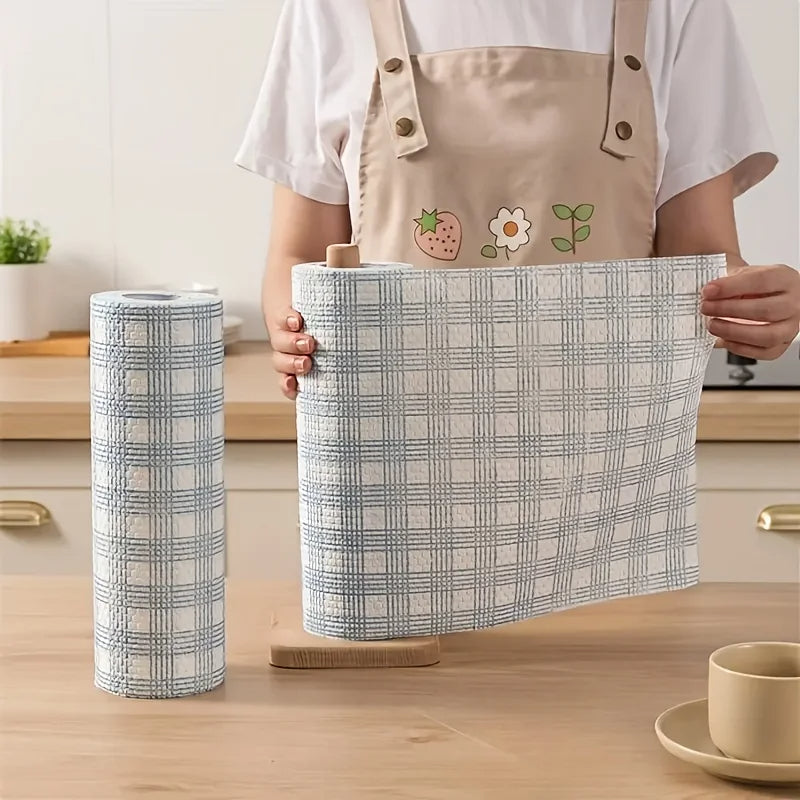 Person holding a checkered fabric basket with a cylindrical fabric roll on a wooden surface.