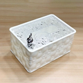 White textured pet water fountain on a wooden surface