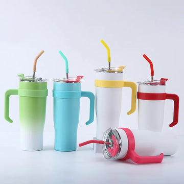 Set of colorful tumblers with handles and straws on a white background