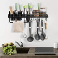 Kitchen utensil rack with various utensils hanging on a wall above a countertop.
