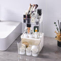 Clear acrylic cosmetic organizer with various items on a bathroom counter.