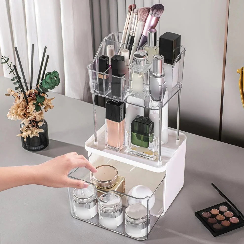 Clear acrylic cosmetic organizer with various items on a bathroom counter.