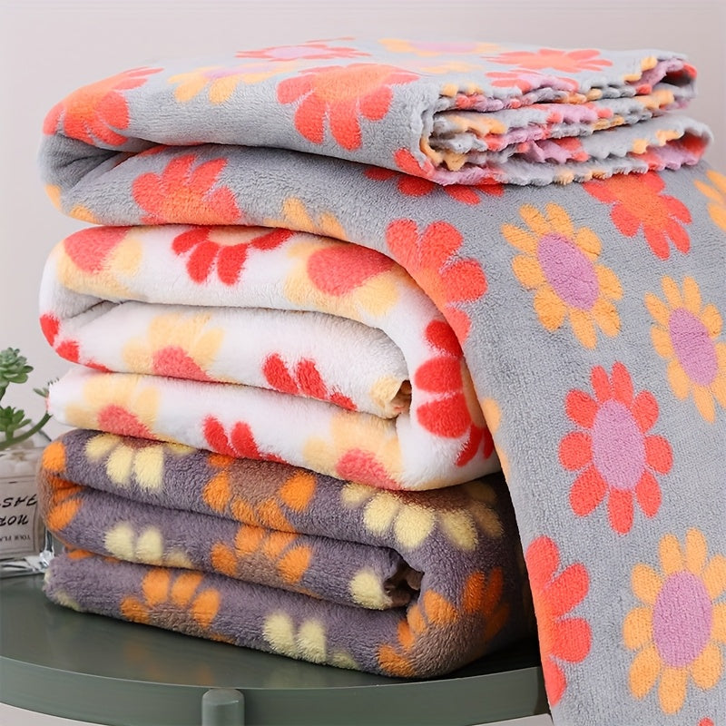 Stack of floral-patterned blankets on a green surface