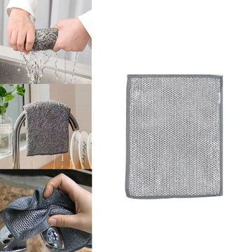 Gray cleaning cloth being used to clean a faucet and a dish, with a plain white background.