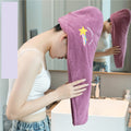 Person using a purple hooded towel with a star design in a bathroom.