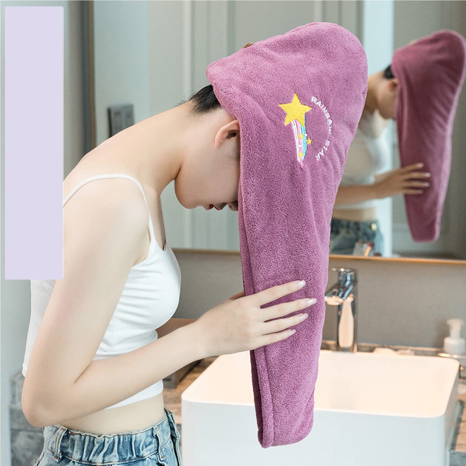 Person using a purple hooded towel with a star design in a bathroom.