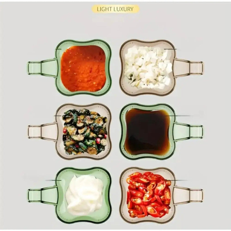 Set of glass condiment containers with food on a white surface