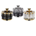 Set of three decorative canisters with gold and black accents on a white background