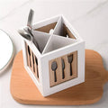 White and wooden cutlery holder with utensils on a white background