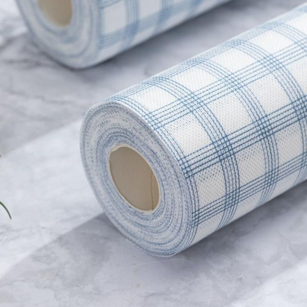 Roll of checkered wallpaper on a marble surface