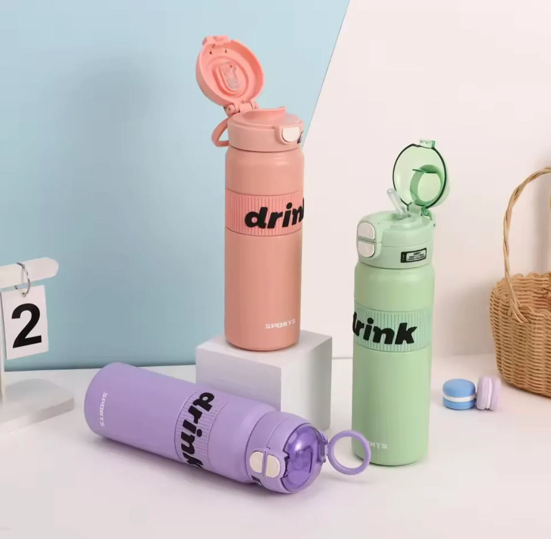 Three colorful water bottles with 'drink' text on a light background