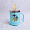 Turquoise mug with space-themed design and yellow straw on a light gray background