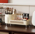 Makeup organizer with brushes and products on a desk