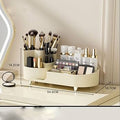 Makeup organizer with brushes and products on a reflective surface