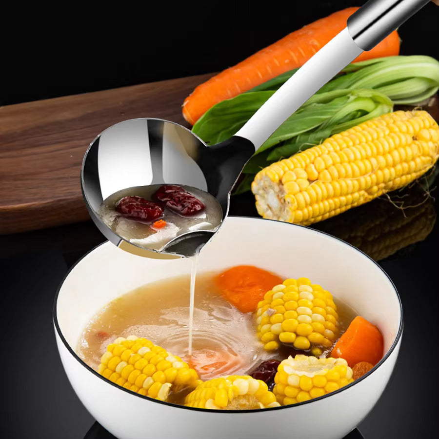 Bowl of soup with corn, carrots, and a ladle, surrounded by vegetables on a dark background