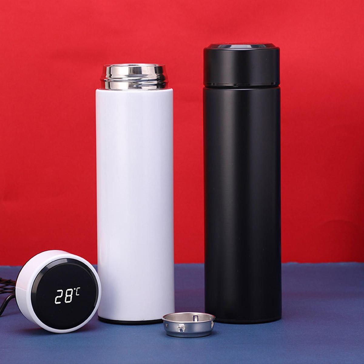 Two thermos bottles, one white and one black, with a digital thermometer on a red and blue background.