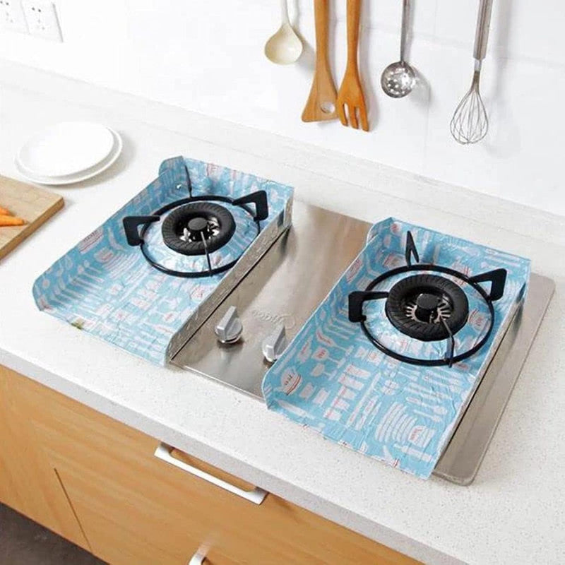 Gas stove with blue flame design covers on a kitchen counter.