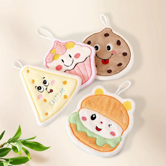 Four cartoon-themed pot holders hanging on a wooden rack with a hand reaching for one of them.