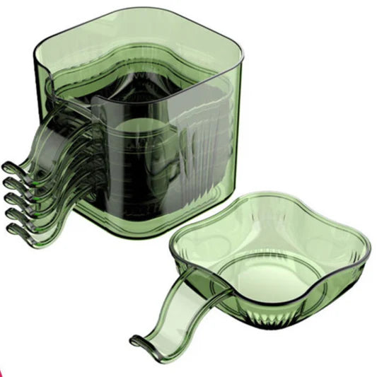 Green plastic kitchen tool set on a white background