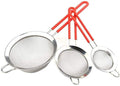 Set of three metal strainers with red handles on a white background