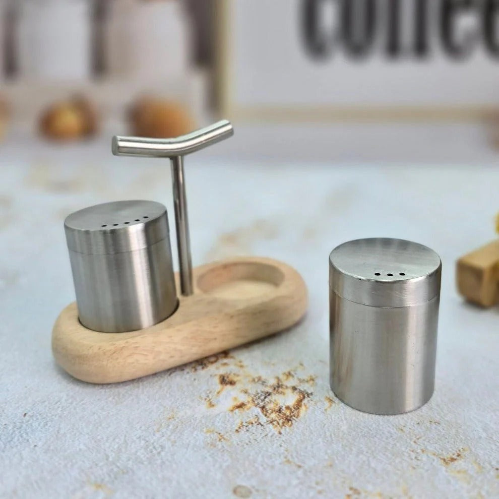 Stainless steel shakers with wooden stand on a kitchen counter