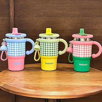 Three colorful children's sippy cups with checkered sleeves on a wooden surface.