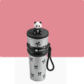White tumbler with black panda design and panda-shaped lid on a pink background
