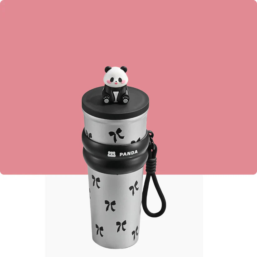 White tumbler with black panda design and panda-shaped lid on a pink background
