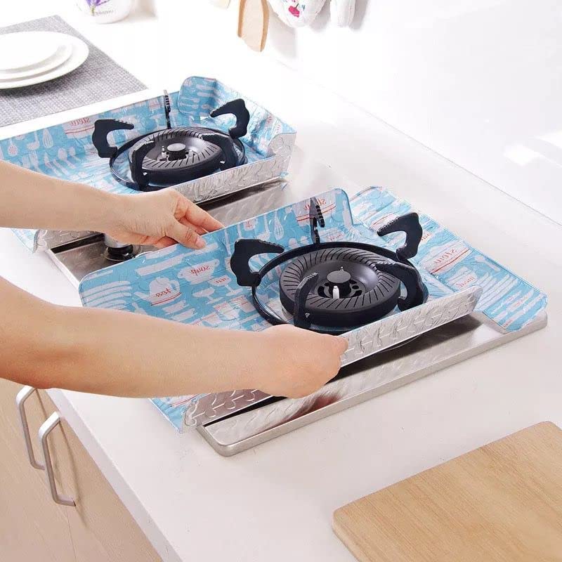 Person placing a portable gas stove on a blue mat with cartoon designs.