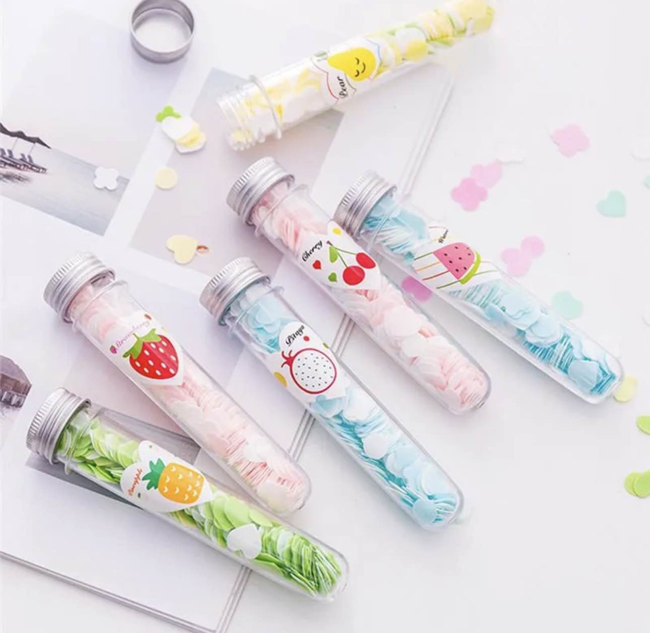 Decorative vials with colorful labels on a white background